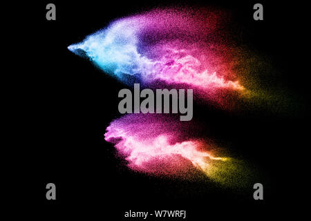 Abstract multicolored sand explosion isolated on black background. Abstract sand cloud. Sandy fly wave in the air. Stock Photo