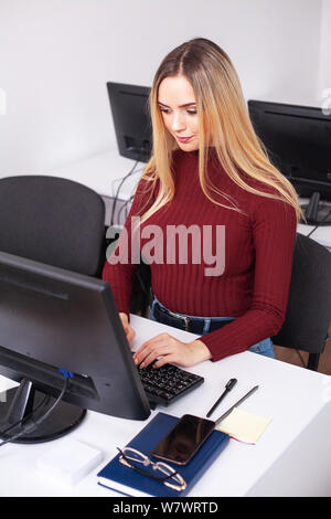 Young Woman Working And Programming On Computer In Office Stock Photo