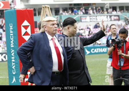 Entertainers resembling U.S. President Donald Trump, left, and Kim Jong-un, supreme leader of the Democratic People's Republic of Korea (DPRK), are pi