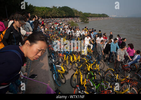 Tourists and bicycles of bike-sharing services crowd the Shenzhen Bay Park during the Qingming festival, or the Tomb-sweeping Day holiday in Shenzhen Stock Photo