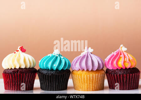 variety colorful cute cupcake on pink background Stock Photo