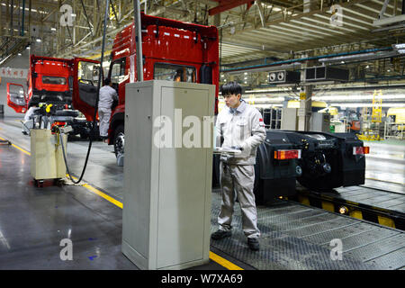 --FILE--Chinese workers assemble trucks on the assembly line at the ...