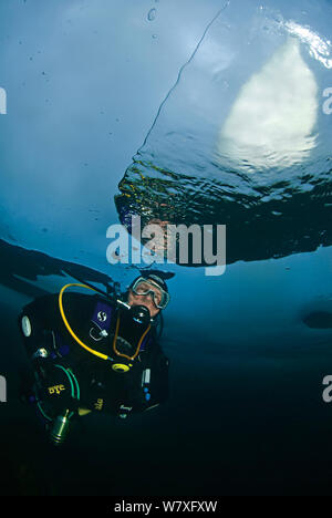 Reflection in air bubble made by diver under surface of the ice. Lake Baikal, Russia, March 2007. Stock Photo