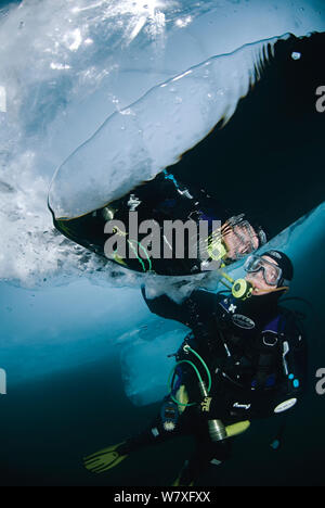 Reflection in air bubble made by diver under surface of the ice. Lake Baikal, Russia, March 2007. Stock Photo
