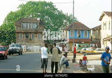 Local people in street scene, buildings typical 19th century colonial architecture, Freetown, Sierra Leone, 2004-2005. Stock Photo