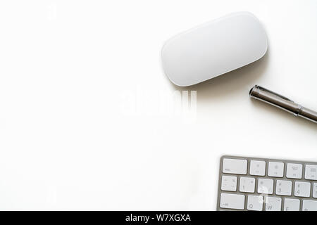 White Table with luxury pen, computer keyboard and mouse Stock Photo