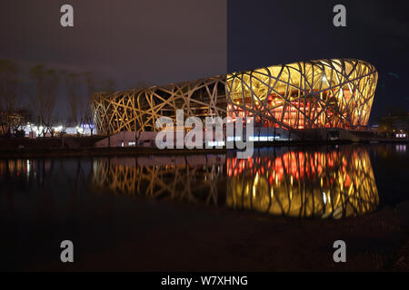 This composite photo shows the Beijing National Stadium, also known as Bird's Nest, before (right) and during the Earth Hour campaign in Beijing, Chin Stock Photo