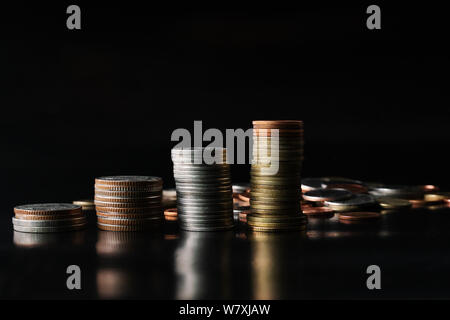 saving coin stack on black background, money saving concept Stock Photo