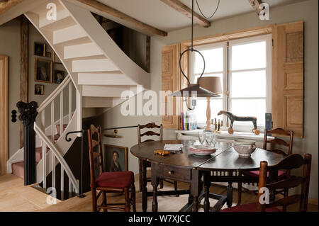 Victorian style dining room by spiral staircase Stock Photo