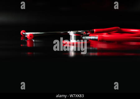 red stethoscope on black background. Healthcare and medicine concept Stock Photo