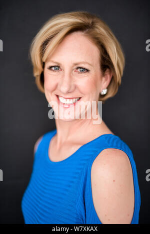 Elegant Adult Woman in Blue Sweater Posing on Dark Background Stock Photo