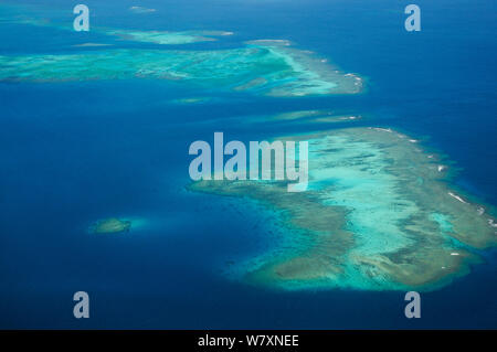 Aerial view of atolls with surrounding coral reefs, off the coast of New Caledonia, September 2008 Stock Photo