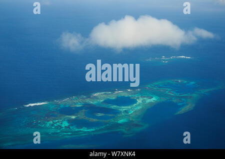 Aerial view of atolls with surrounding coral reefs, off the coast of New Caledonia, September 2008. Stock Photo