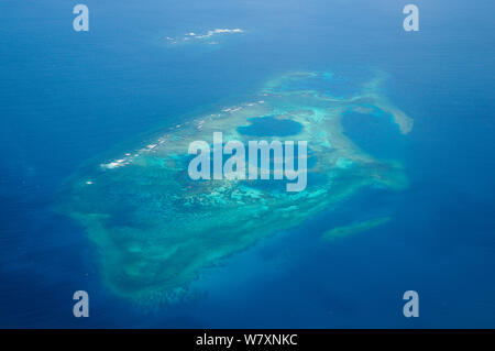 Aerial view of atolls with surrounding coral reefs, off the coast of New Caledonia, September 2008. Stock Photo