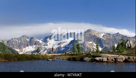 Hiker at Snowy Lakes in the North Cascades area of the Okanogan Wenatchee National Forest, Washington, USA, July 2014. Model released. Stock Photo