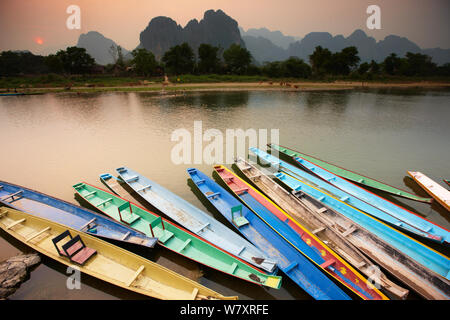 Colourful canoes moored on the Nam Song River at Vang Vieng, Laos, March 2009. Stock Photo