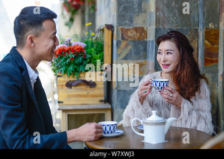 50-year-old Chinese woman Xu Min, dubbed as 'magical beauty', enjoys afternoon tea at a teahouse in Kunming city, southwest China's Yunnan province, 1 Stock Photo