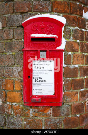 Buckingham, UK - February 01, 2019. A traditional British post box is set into a wall in Buckinghamshire. The post box dates from the reign of George Stock Photo