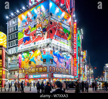 Neon signs and billboards at night on Yasukuni-dori, the main street in Shinjuku, Tokyo, Japan Stock Photo