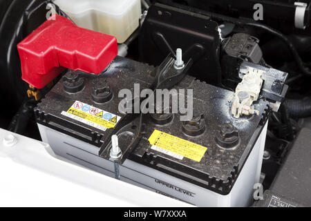 Buckingham, UK - May 16, 2019. Car battery is fitted in a car engine compartment of a Suzuki Jimny. The lead acid car battery is designed for easy rep Stock Photo