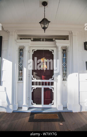 Vintage vertical autumn white front door, Freehold, Manalapan Township, farm house in New Jersey, USA, US, NJ America Pt Halloween decoration Stock Photo