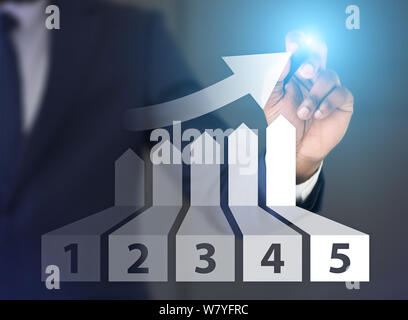 Man drawing graph of growth with five places on screen Stock Photo