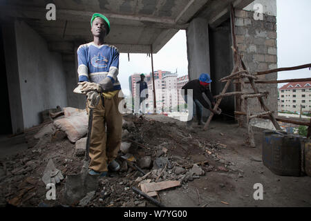 Economic migrant from rural areas working on construction site, Nairobi, Kenya, November 2013. Stock Photo