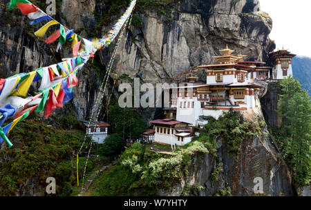 The Tiger&#39;s Nest Monastery rocky mountainside with prayer flags,  near the town of Paro. Bhutan, October 2014. Stock Photo