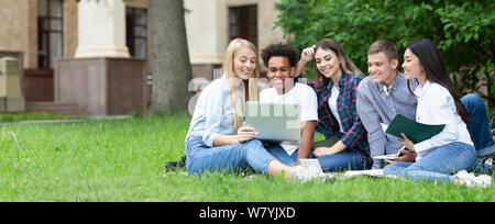 Team of students studying in group project outdoors Stock Photo