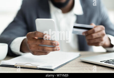 Dark-skinned man making hotel reservation via internet Stock Photo