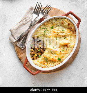 Shepherd's Pie with ground beef, potato and cheese on white background, top view, copy space. Traditional homemade casserole - Shepherds Pie. Stock Photo