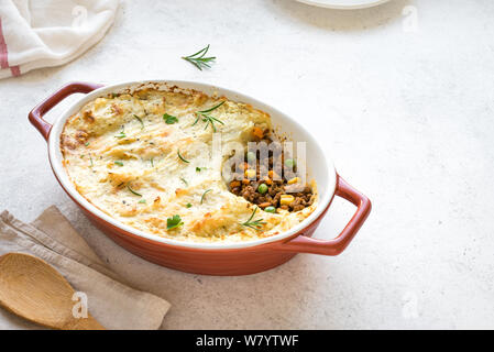 Shepherd's Pie with ground beef, potato and cheese on white background, top view, copy space. Traditional homemade casserole - Shepherds Pie. Stock Photo