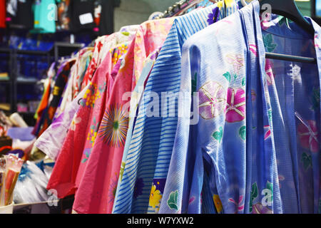 Traditional Japanese female summer garments called 'Yukata' with floral patterns on a rack Stock Photo