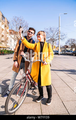 Young couple with bicycle takes selfie together Stock Photo