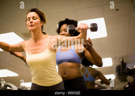Two women working out together at the gym. Stock Photo