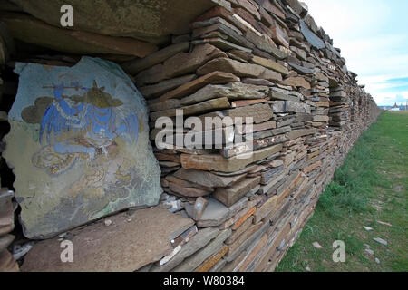 Tibetan art work in wall on Mani prayer stones, Serxu, Shiqu county, Sichuan Province, Qinghai-Tibet Plateau, China. August 2010. Stock Photo