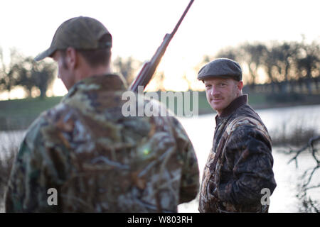 Two male hunters wearing camouflage clothing Stock Photo