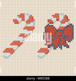Candy cane one with a large red bow in a cross stitch pattern on tetured material Stock Photo