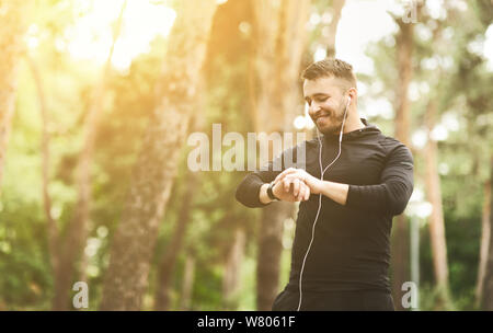 Young athlete checking fitness progress on smart watch Stock Photo