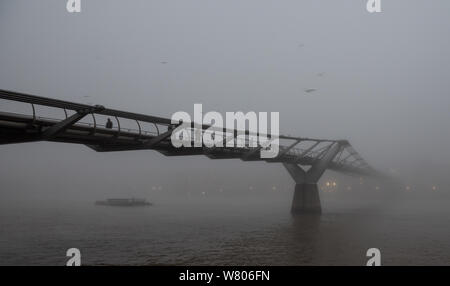 Tower Bridge, London, UK. 2nd November, 2015. Londoners wake up to a blanket of thick fog hanging over the capital. Pictured:  People walk over the Mi Stock Photo