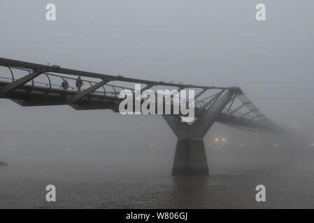 Tower Bridge, London, UK. 2nd November, 2015. Londoners wake up to a blanket of thick fog hanging over the capital. Pictured:  People walk over the Mi Stock Photo