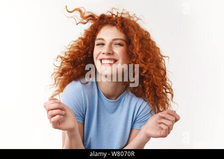 Flirty woman having naughty thoughts in mind rolling lock of hair