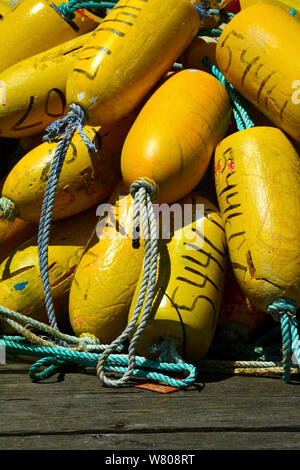 Crab trap floats and buoys pilled on a commercial fishing vessel in a