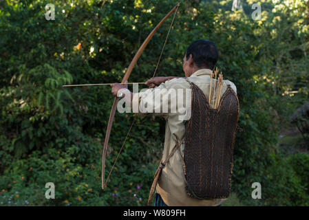 Adi Gallong man with bow and arrow. Adi Gallong Tribe. Arunachal Pradesh, North East India, October 2014. Stock Photo