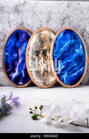 Odessa, UKRAINE - August. 10, 2019: Cutting board with marine abstract handmade pattern, flowers on a light wooden surface. Rostik and adriatic sea st Stock Photo
