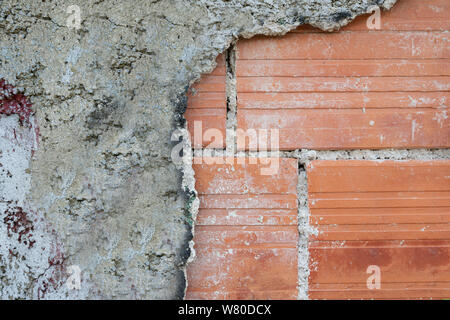 the old plaster stripped from the wall Stock Photo