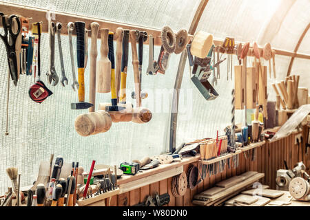 Woodwork workshop workbench with many different tools and equipment. Carpentry craftsman work bemch. DIY handmade furniture industry Stock Photo