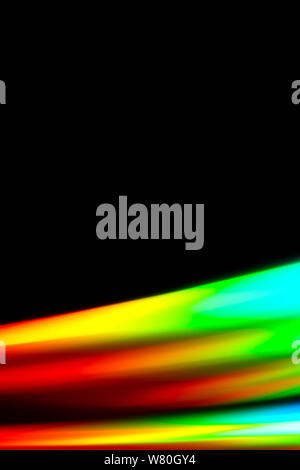 Beams of light refracting and creating a rainbow spectrum of colours against a black background Stock Photo