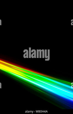 Beams of light refracting and creating a rainbow spectrum of colours against a black background Stock Photo