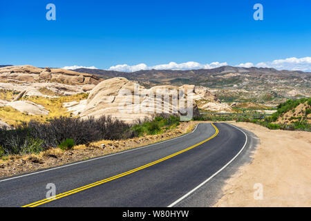 Downhill rural highway with mountain view in Southern California Stock Photo